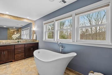 a large bathroom with a huge tub in the middle of it