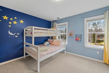 this children's bedroom is painted bright blue with a star and crescent