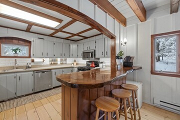 Modern kitchen interior with wooden table and rustic elements