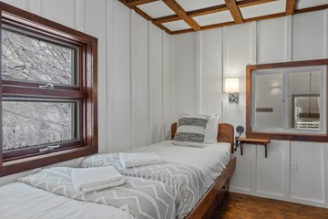 Small beds in a white bedroom next to each other