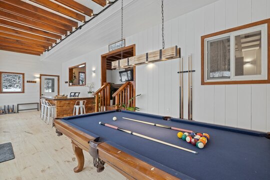 Large pool table in a room with wooden elements