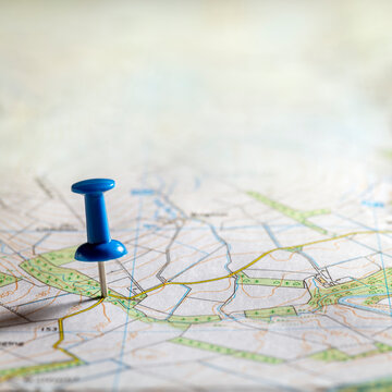 Blue thumbtack marking and showing destination location point on map background with copy space