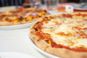 Margherita pizza or Margarita pizza on wooden background. Close up homemade fresh Italian Margherita or Margarita pizza with cheese, gourmet, basil. Pizza is traditional food for Italian on Italy.