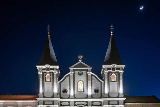 Tower of the white St. Paul church on the market square of Zilina at night, Slovakia