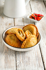 curry puff or pastel goreng is pastry popular in Indonesia. fried pastry with filling sauteed vegetable, chicken and bolied egg.