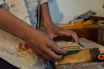 Closeup shot of a young female artist working on art in her messy studio