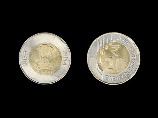 closeup of an indian 20 rupees coin, front and back isolated in a black background