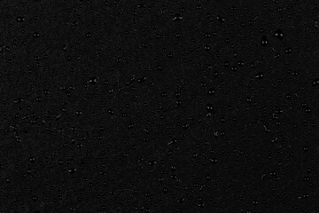 Water drops on dark stone