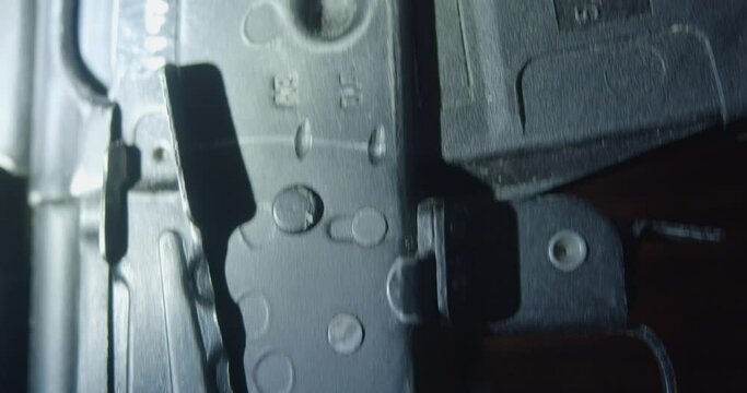Camera moving along the Kalashnikov assault rifle. Vertical 4k video.