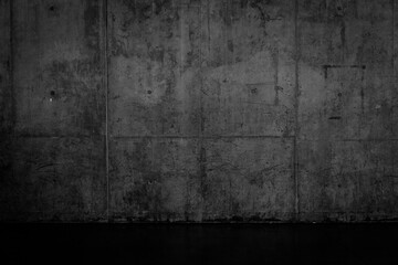 Grungy dark concrete wall and wet floor