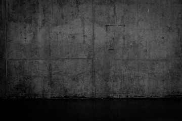 Grungy dark concrete wall and wet floor