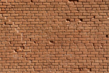 Shot of an old red brick wall with damaged texture