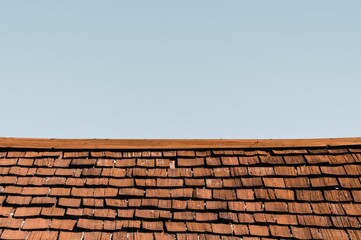Old wooden rustic roof with a blue sky in the background