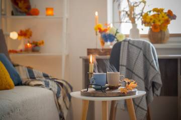 two  cups with hot drinks at home with autumnal decor