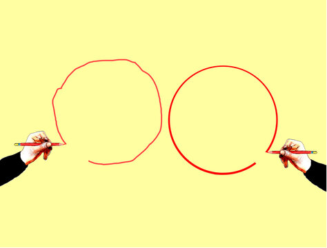 Hands of two people drawing circles against yellow background