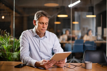 Portrait of businessman in office. Man using digital tablet. Businessman having video call