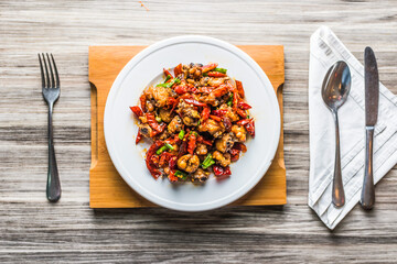 Szechuan Fried Chicken With Dried Red Chilli isolated on wooden board top view on table fastfood