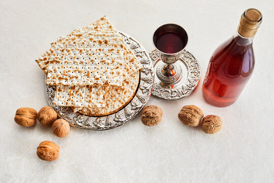 Passover celebration concept. Matzah, red kosher and walnut.