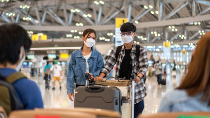 Young friend traveler in quarantine for coronavirus wearing surgical mask face protection with luggage flight travel before long travel vacation flight at International terminal airport