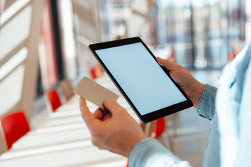 Businessman with credit card and tablet PC