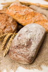 Homemade natural breads. Different kinds of fresh bread as background, perspective view with copy space