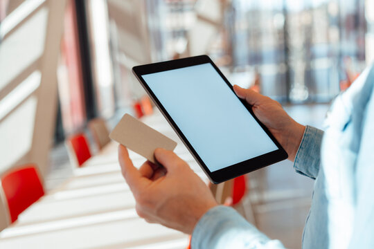 Businessman with credit card and tablet PC