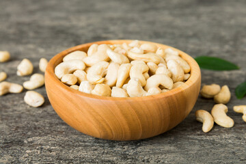 cashew nuts in wooden bowl on table background. top view. Space for text Healthy food