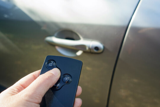 Woman locking car with card key