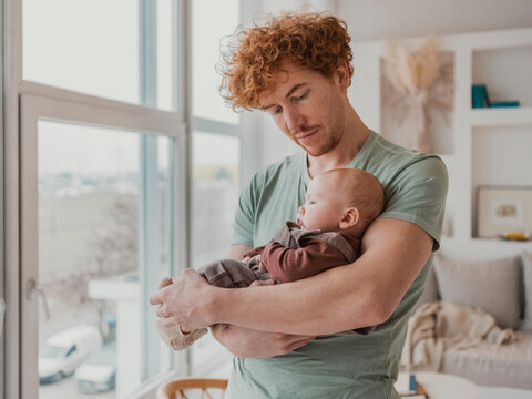 Father spending time and taking care of baby boy at home
