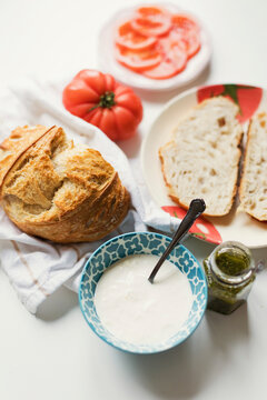 Artisan bread with cheese and pesto sauce on table