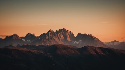Fototapeta na wymiar A serene sunset over a mountain range with warm, golden tones illuminating the peaks