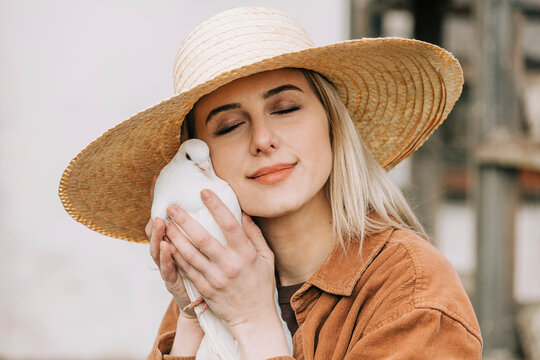 Farmer Wearing Straw Hat Holding Dove