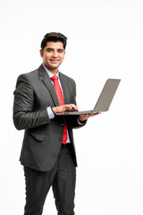 Young indian Businessman using laptop on white background.