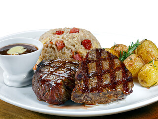 Grilled steak with rice and boiled potatoes