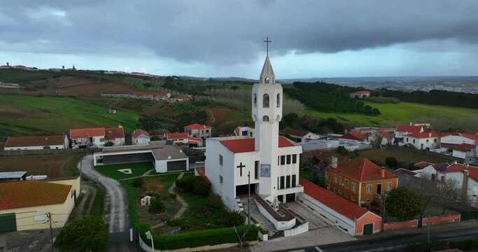 Aerial view of a small Beautiful Church in Portugal. Amazing drone view of Igreja Paroquial de Casal Novo during sunset.