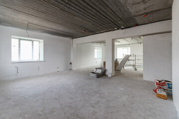 Fototapeta premium Spacious empty rooms in the attic floor after filling out the work on the wall and ceiling