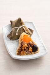 Zongzi, rice dumpling for Dragon Boat Festival on wooden table background with ingredient.