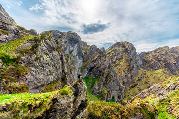 Mountain of Aiako Harria or Penas de Aya in the municipality of Oiatzun, Basque Country. man sitting on top