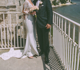 Bridal couple on a balcony by the sea - 588325997