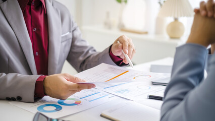 Fototapeta premium Two business people Team meeting process.Photo young business managers crew working with new startup project.Using modern smartphones, texting message, analyze plans.