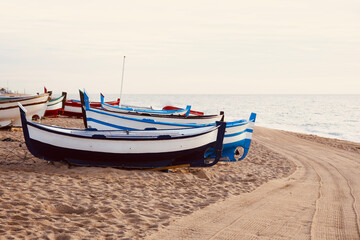 Old wooden boat in the sand. Colorful fishing boats on the beach.