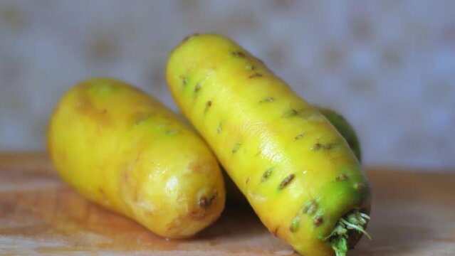 Close-up of a fresh yellow carrots in soft focus on kitchen.