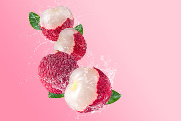 Creative layout made from Fresh lychee or litchi fruit and water splashing on a pastel pink background. Fruit minimal concept and copy space.