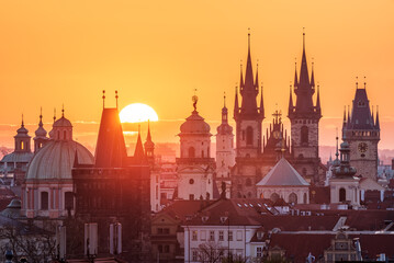 A rising sun above the cityscape of Prague. 