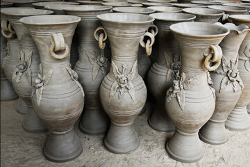 Fototapeta na wymiar A batch of large vases is ready for the next stage of kiln firing. Pottery work of Comilla, Bangladesh. 