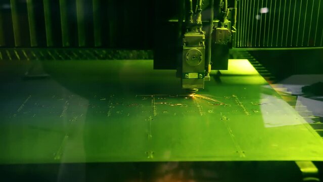 Laser cutting in automatic mode. The laser cuts metal and makes electronic circuit boards. Manufacture of microchips, printed circuit boards.