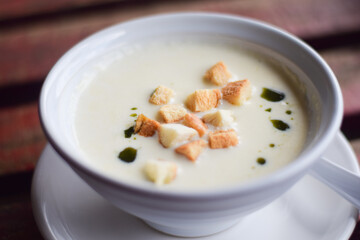 mushroom soup in bowl on wooden table