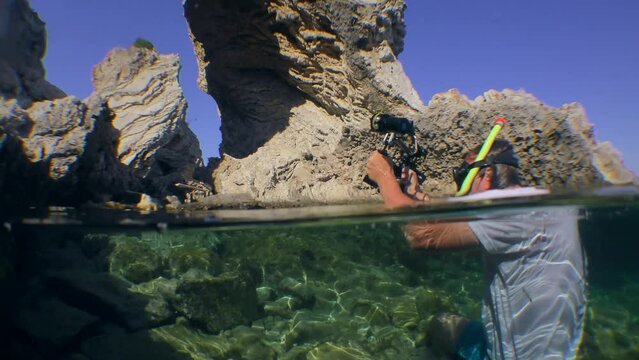 Mediterranean Seascape, An Underwater Cameraman Raises A Camera Above The Water To Capture A Coastal Rock In The Form Of An Arch, Split.