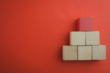 Blank wooden cubes for put text,logo or infographic stacking in pyramid shaped in right corner with copyspace over red background use for lat lay top view mock-up item,business and design concept.