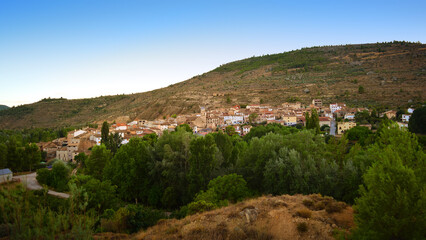 Fototapeta na wymiar View of the village of Casas Altas in Rincón de Ademuz, Valencia, moments before nightfall. Summer 2022